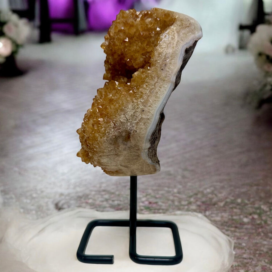 Golden Citrine Crystal Geode Displayed on a metal stand